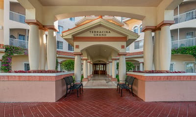 Entrance to Terracina Grand facility with columns and landscaping