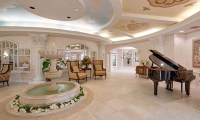 Elegant lobby with a grand piano and fountain