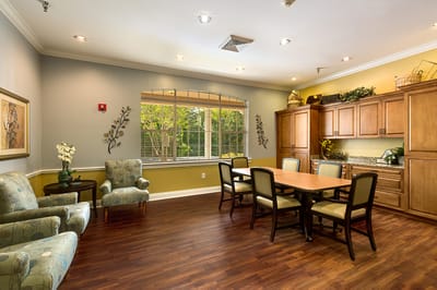 Bright common area with seating and kitchen facilities
