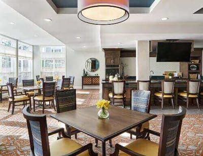 Bright dining area with tables and flower centerpieces