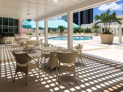 Outdoor pool area with chairs and shade