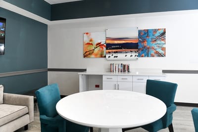 A cozy common area with colorful artwork.