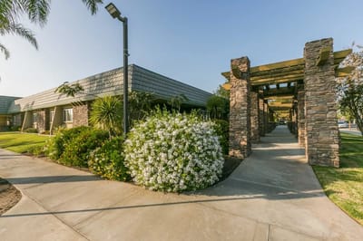 Exterior view of the facility with landscaping and pathway