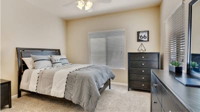 A well-appointed resident bedroom with light decor