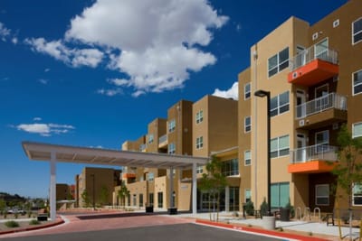 Exterior view of a senior living facility with a covered entrance