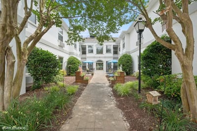 Pathway through a landscaped courtyard with seating areas