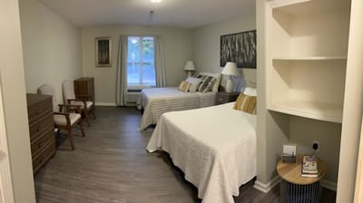 Bright, airy shared bedroom in a senior living facility