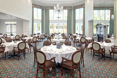Elegant dining room with set tables and large windows