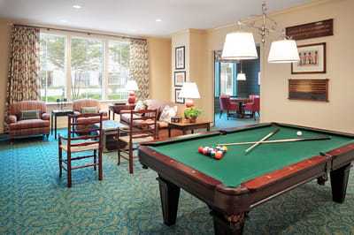 A billiards table in a cozy common area