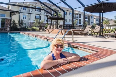 Resident enjoying the pool area at the community
