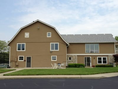 Exterior view of a senior living building with lawn