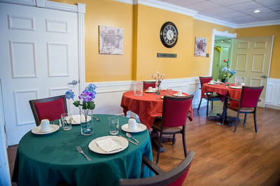 Dining room setup with tables and flowers