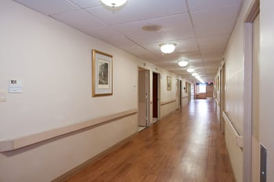 Interior hallway with wooden flooring and lighting