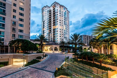 Exterior view of a modern senior living facility with palm trees