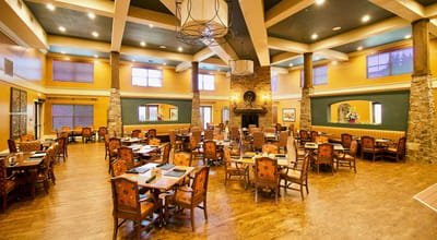 Spacious dining area with wooden furniture and warm lighting