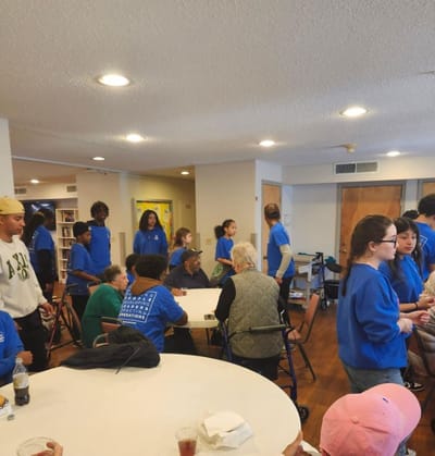 Volunteers interacting with residents in an activity room