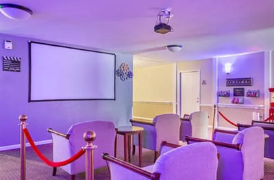 Interior common area with seating and a projector screen