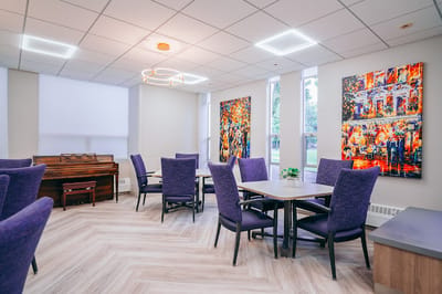 Bright common area with purple chairs and colorful artwork