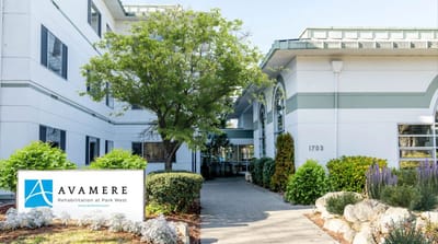 Building entrance with landscaping and facility logo