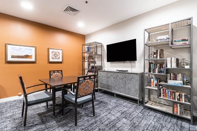 Cozy common area with a table and bookshelf