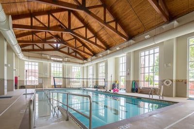 Indoor pool area with a vaulted wooden ceiling