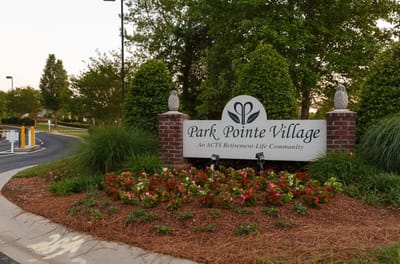 Signage for Park Pointe Village in landscaped garden