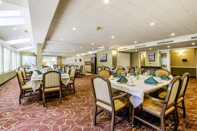 Dining area with elegantly set tables for residents