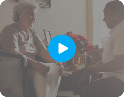 Senior resident enjoying conversation with staff member