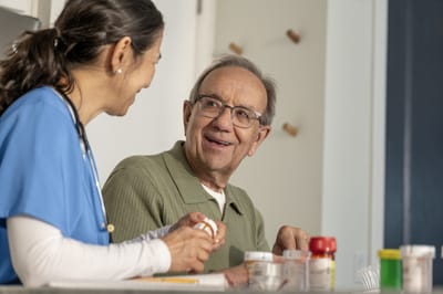 Caregiver and resident interacting during medication management