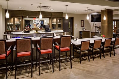 Interior of a bar area with high stools and a counter