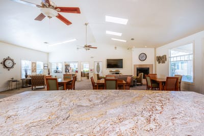 Bright common area with seating and dining tables