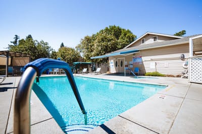 Swimming pool area with lounge chairs and building