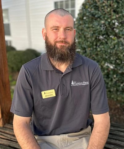 A staff member posing outdoors at Florence Place