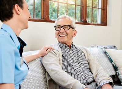 Staff member engaging with a smiling resident