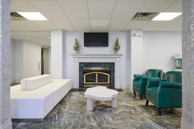 A cozy common area with seating and a fireplace