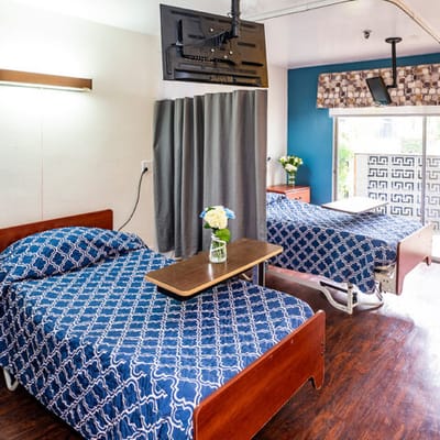 Private resident room with twin beds and flowers