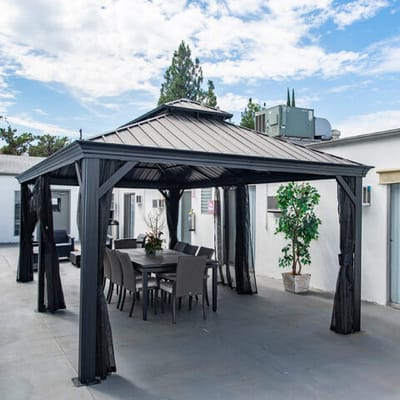 A gazebo with dining furniture in an outdoor space