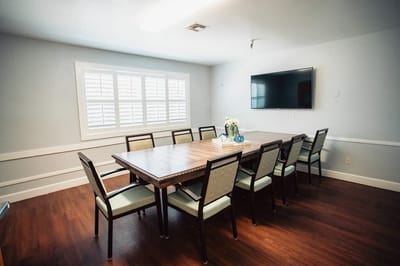 Bright meeting room with large table and chairs