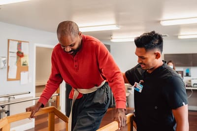 Staff assisting a resident during rehabilitation