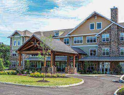 Exterior view of a senior living facility with gardens