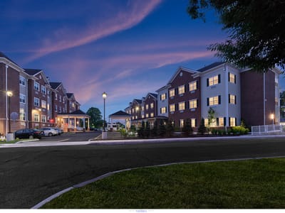 Exterior view of Chelsea Senior Living at dusk