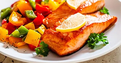 Heartis Longview Assisted Living, memory care in Longview, TX — Grilled salmon fillets with colorful peppers and lemon slices