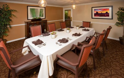 Dining room set for a meal with table and chairs