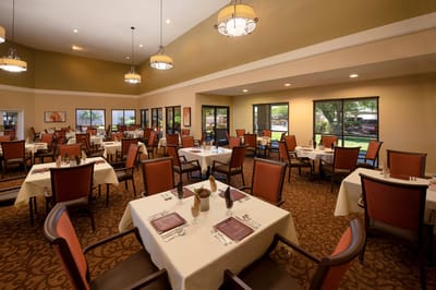 Dining room with neatly set tables and natural light