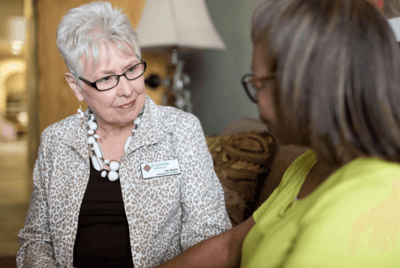 Care staff interacting with a resident in a common area