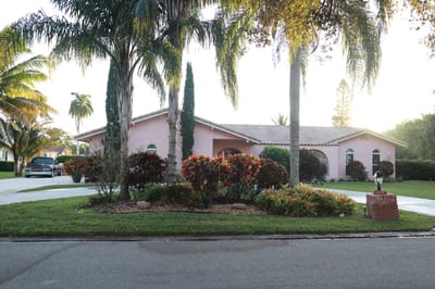Exterior view of a senior living facility with landscaped garden