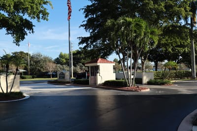 Entrance of Park Summit with palm trees and flag