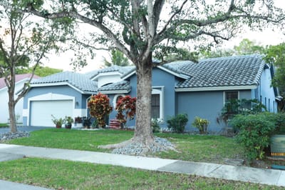 Exterior view of a senior living facility with gardens