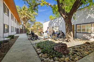 Residents enjoying a gathering in a shaded outdoor area