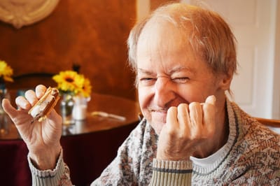 Resident enjoying a sandwich in a dining area